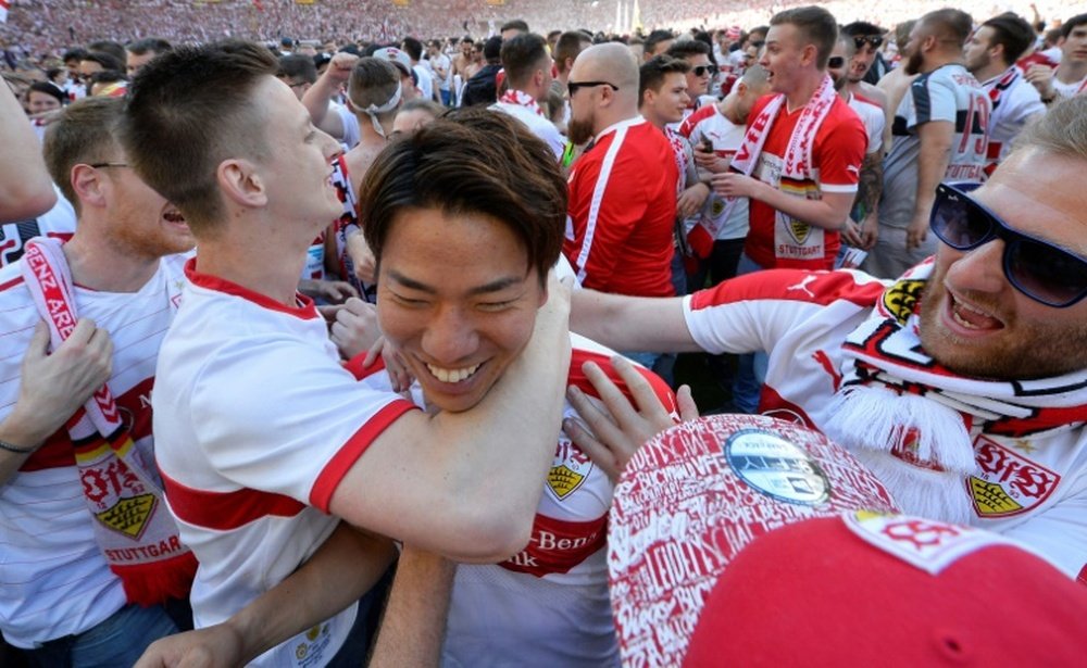 Takuma Asano is celebrated by fans. AFP