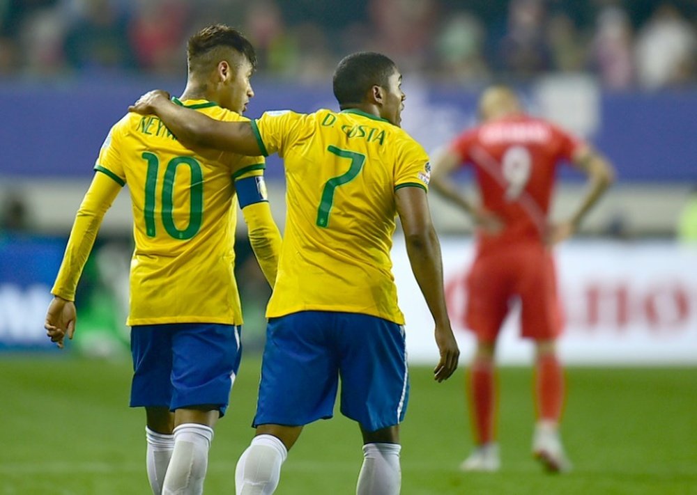 Brazils Douglas Costa (R) and Neymar (L), pictured on June 14, 2015, are heading a young Brazil Olympic football squad for the Rio Games