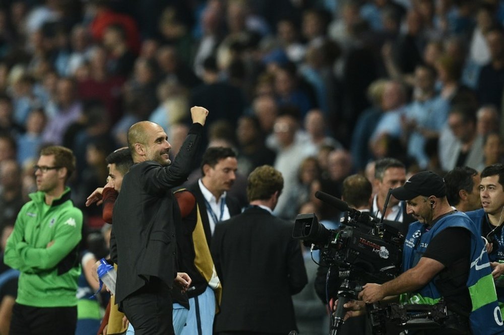 Guardiola celebrates a Champions League victory with Man City. AFP