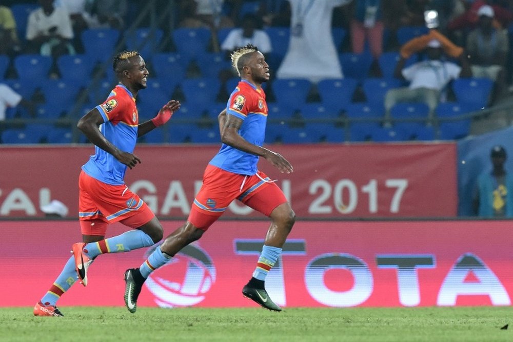Democratic Republic of the Congos forward Junior Kabananga (R) celebrates with midfielder Merveille Bokadi after scoring a goal on January 16, 2017