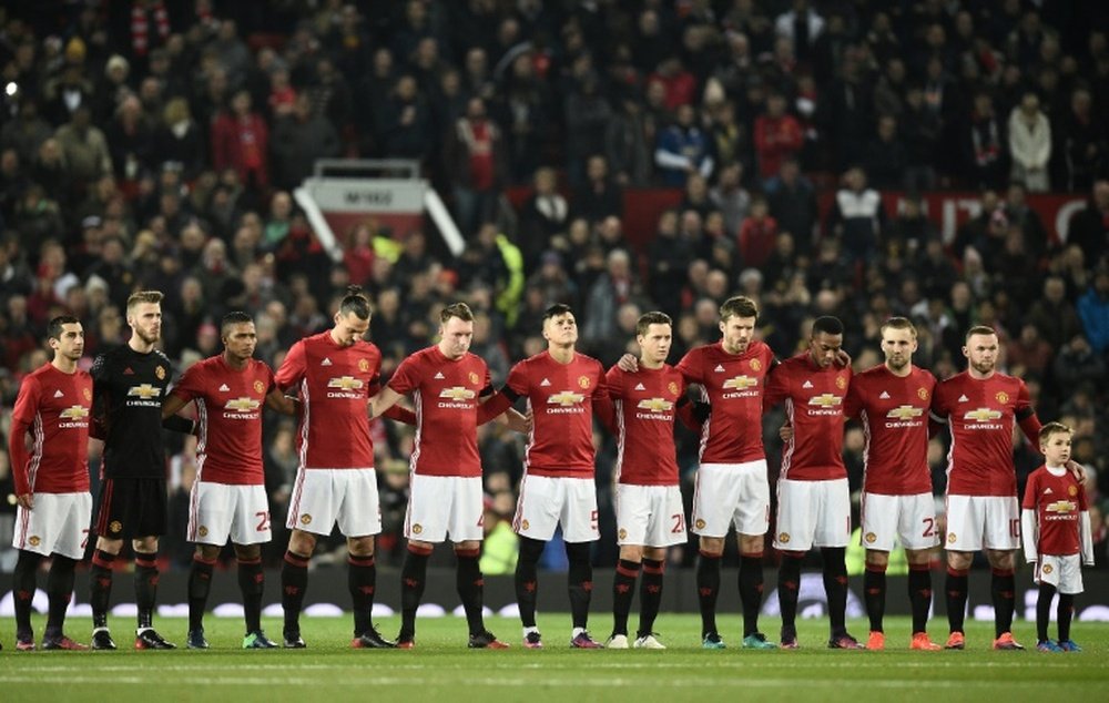 United players stand during the minute's silence ahead of their EFL Cup clash with West Ham. AFP