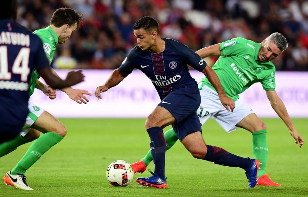 Paris Saint-Germains French forward Hatem Ben Arfa (C) vies with Saint-Etiennes French defender Loic Perrin during the French L1 football match between Paris Saint-Germain and Saint-Etienne