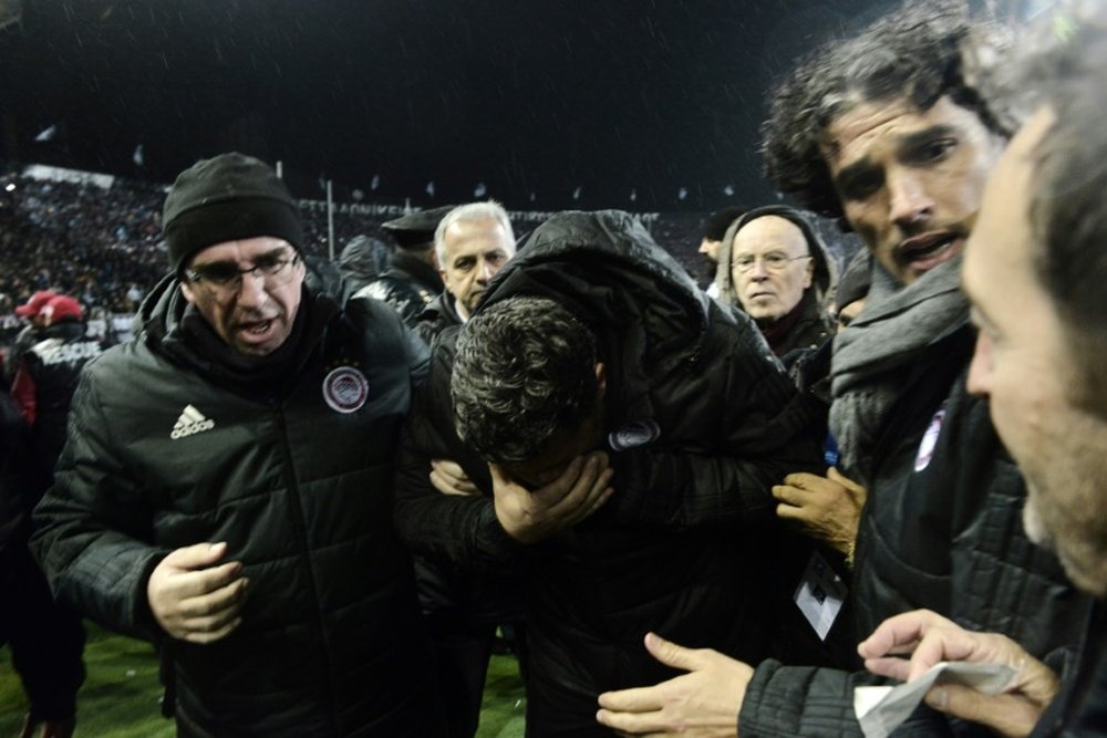 Police guard for coach injured by toilet roll at Greek game. AFP
