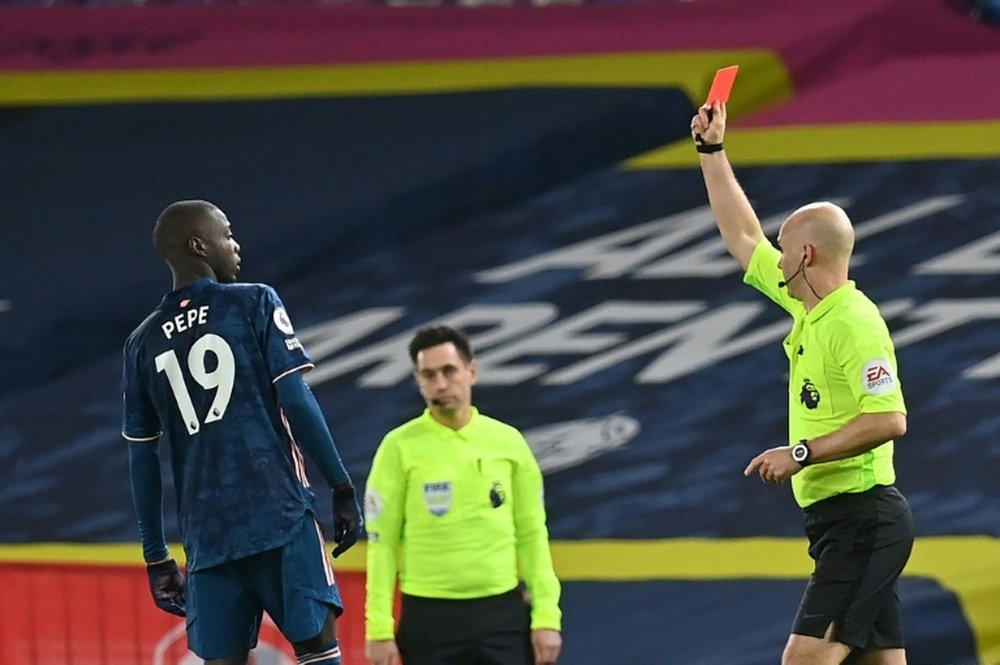 Arsenal held out for a 0-0 draw at Leeds despite Nicolas Pepe's (left) red card. AFP