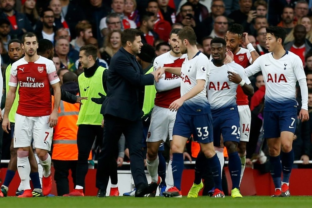 Pochettino tried to keep the peace as players clashed after Tottenham's equaliser at Arsenal. AFP