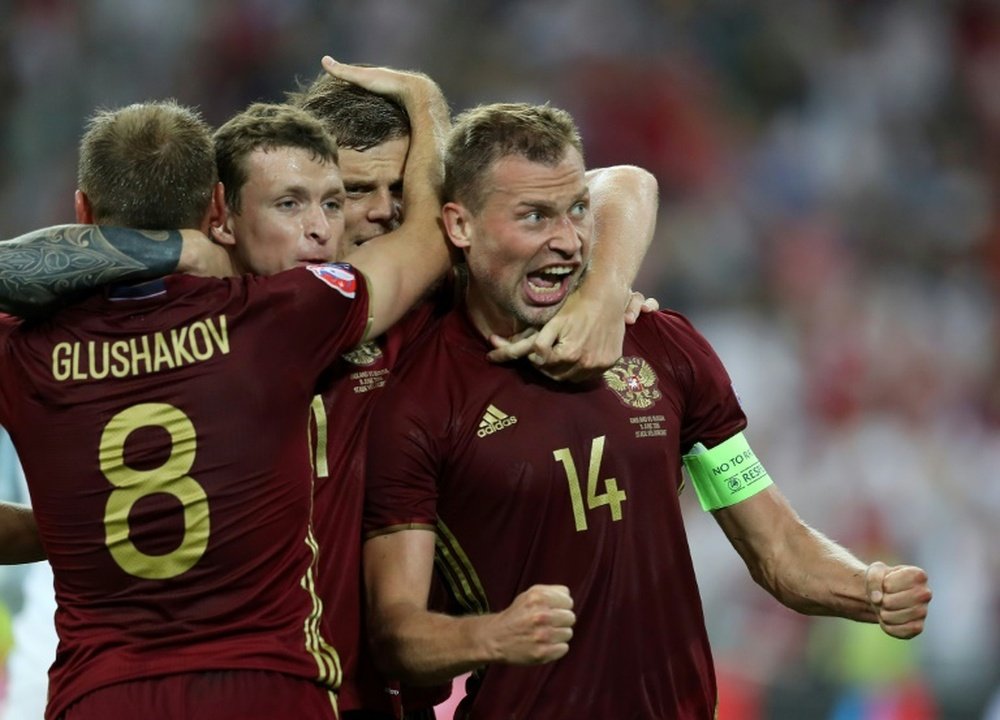 Russias Vasili Berezutski (R) is congratulated by teammates after scoring the equaliser against England in their Euro 2016 group B match