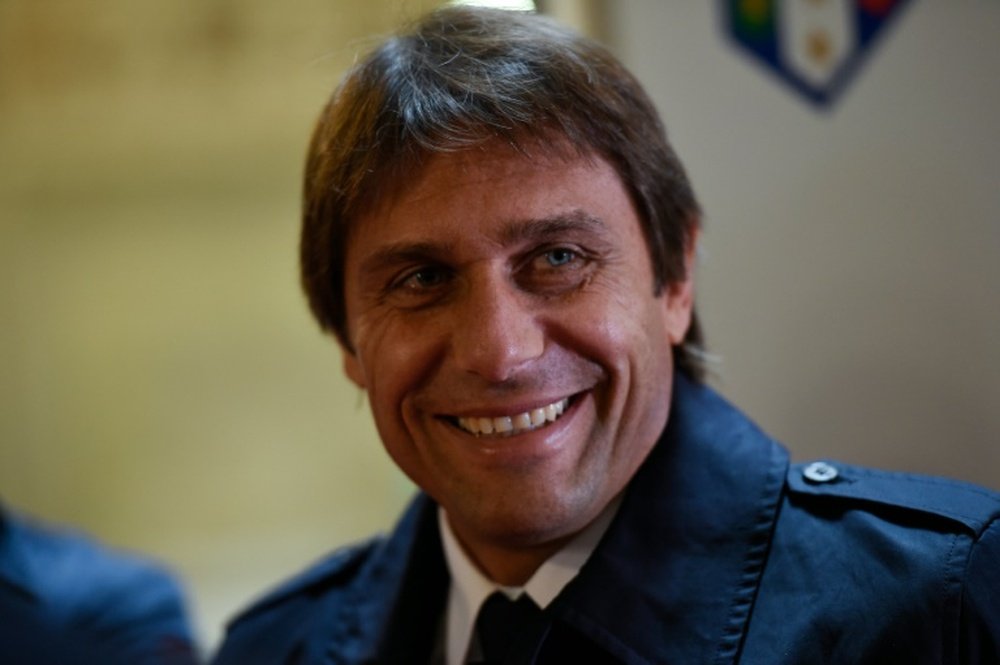 Italys national football team coach Antonio Conte smiles as he attends the presentation of the new jersey of the Italian national football team for the EURO 2016 tournament, on November 9, 2015 at the Palazzo Vecchio in Florence