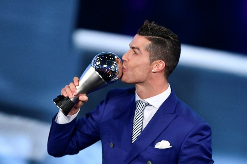 Cristiano Ronaldo kisses his trophy after winning the The Best FIFA Men's Player of 2016. AFP