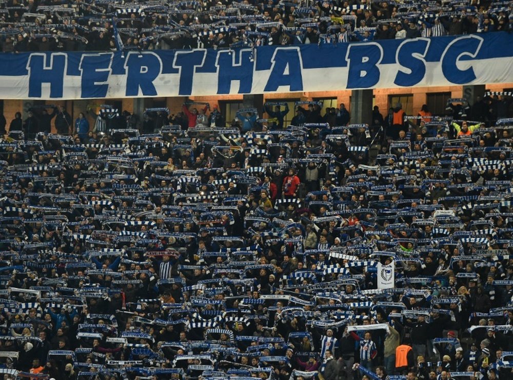 Supporters of Hertha salute their team before a German first division Bundesliga football match in Berlin, on March 2, 2016