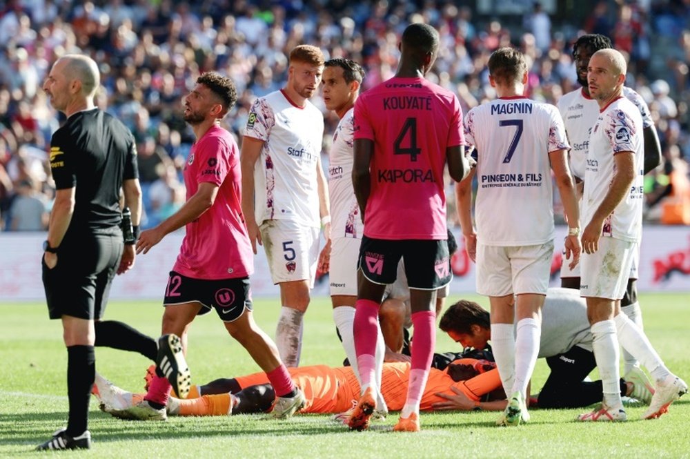 Diaw (C) lay on the ground after a firecracker exploded next to him in the Montpellier clash. AFP