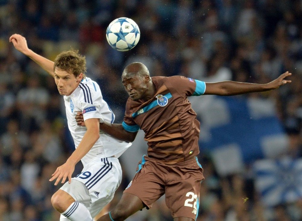 Denys Garmash (L) of FC Dynamo Kiev vies with Danilo of FC Porto during the UEFA Champions league group G football match at Olimpiysky stadium in Kiev on September 16, 2015