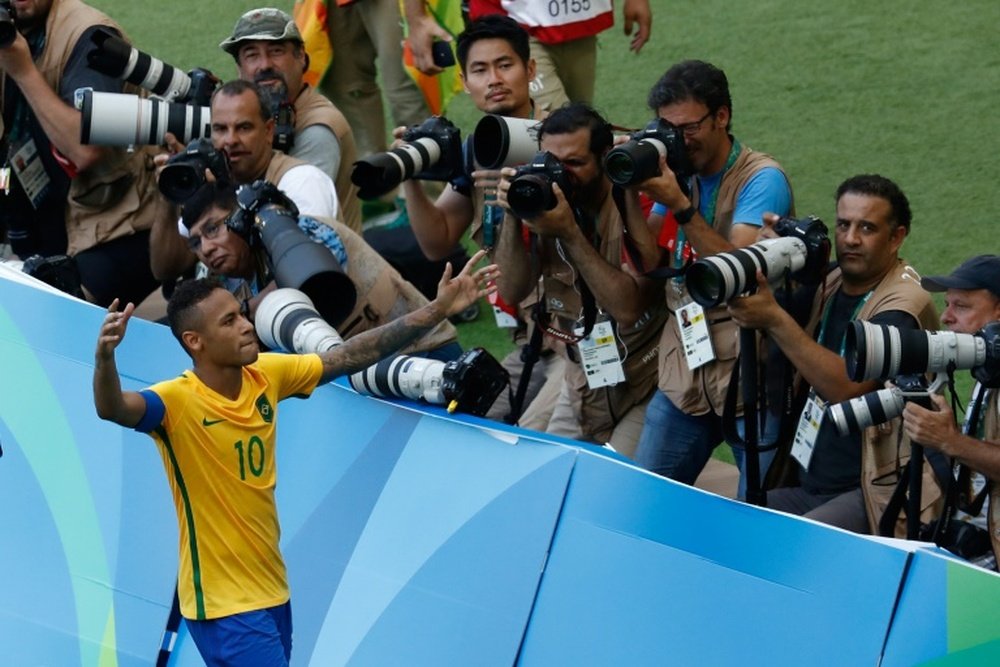 Neymar celebrates after scoring a penalty against Honduras. AFP