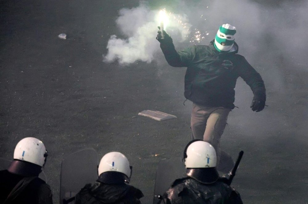 Riot police clashes with football fans during the game between Athens arch-rivals Olympiakos and Panathinaikos on February 22, 2015 in Athens