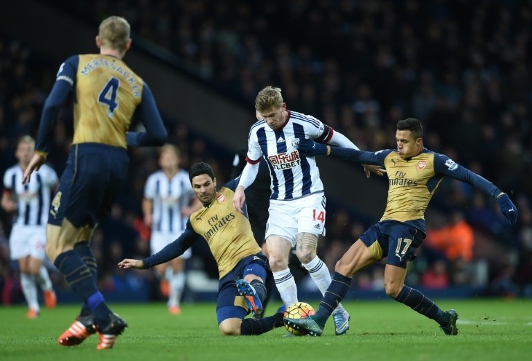 West Bromwich Albions midfielder James McClean (2R) vies with Arsenals Alexis Sanchez (R) and Mikel Arteta during the match at The Hawthorns in West Bromwich on November 21, 2015