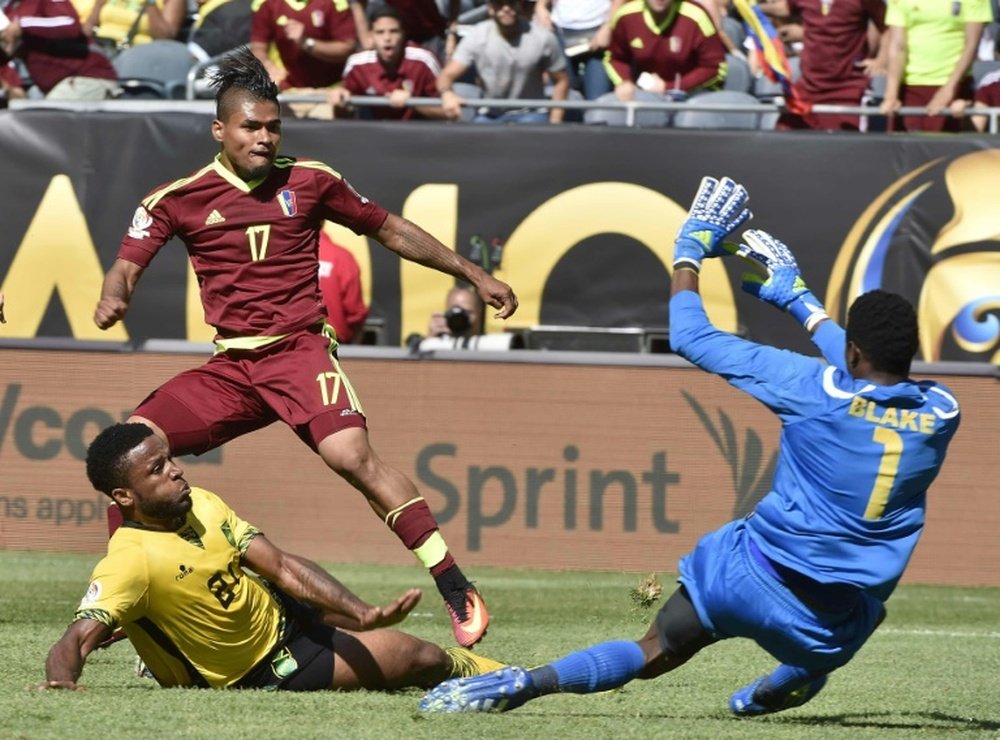 Venezuelas Josef Martinez scores past Jamaicas Andre Blake (R) during their Copa America Centenario match, at Soldier Field Stadium in Chicago, on June 5, 2016