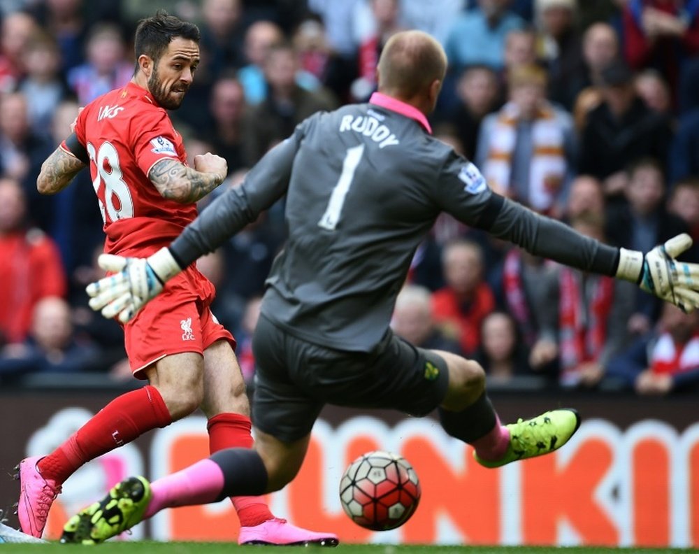 Liverpools striker Danny Ings (L) scores past Norwich Citys goalkeeper John Ruddy during an English premier league football match at Anfield in Liverpool, England on September 20, 2015