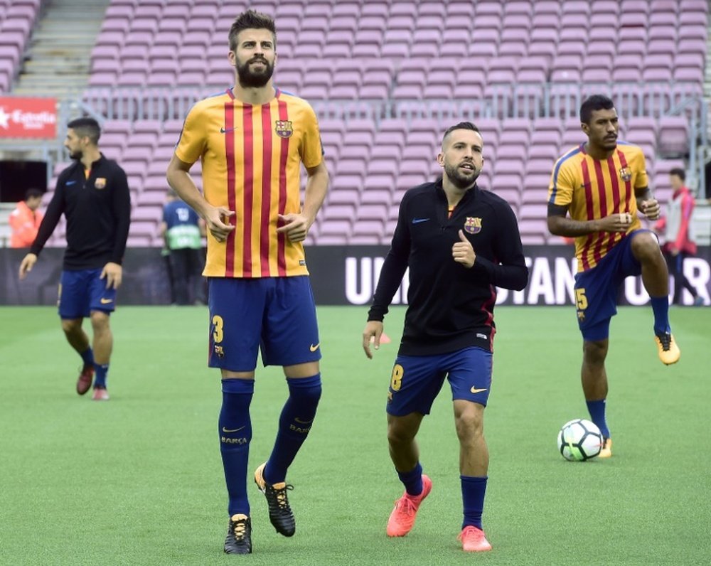 Pique warms up with Alba at an empty Nou Camp. AFP