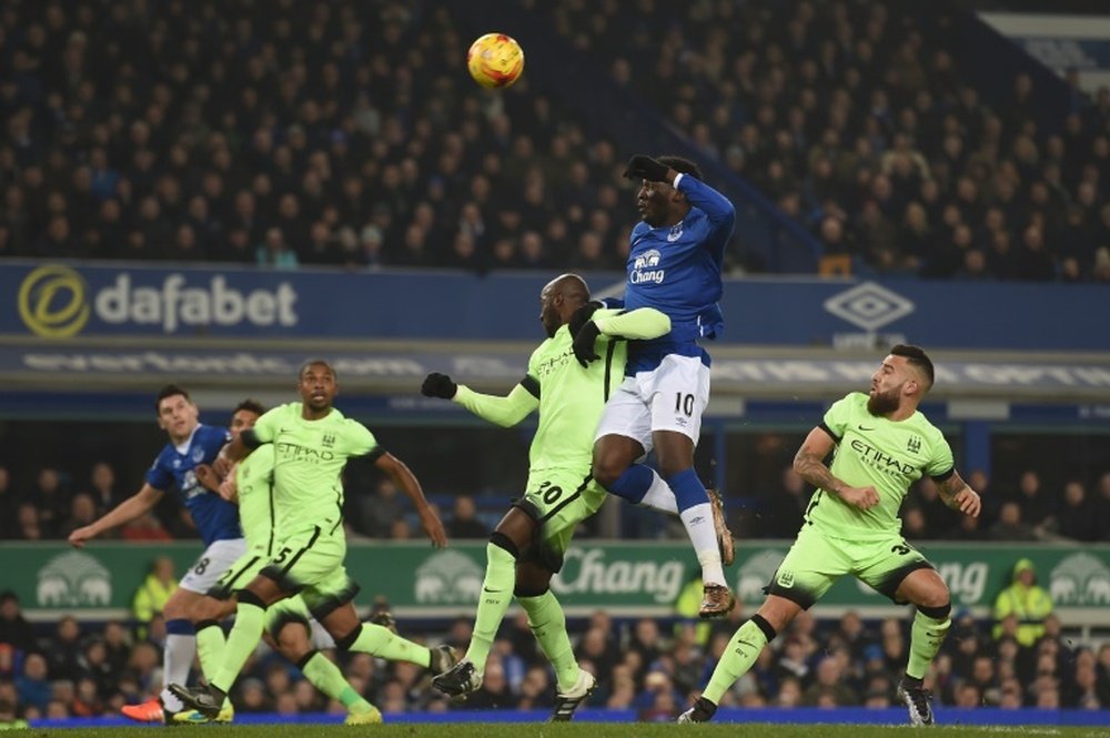 Evertons striker Romelu Lukaku (2R) goes up for a header against Manchester Citys defender Eliaquim Mangala (3R) during the English League Cup semi-final first leg football match at Goodison Park in Liverpool, England on January 6, 2016