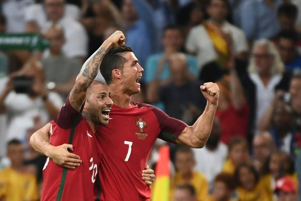 Portugal forwards Ricardo Quaresma (L) and Cristiano Ronaldo celebrate after winning the Euro 2016 quarter-final match between Poland and Portugal, on June 30, 2016