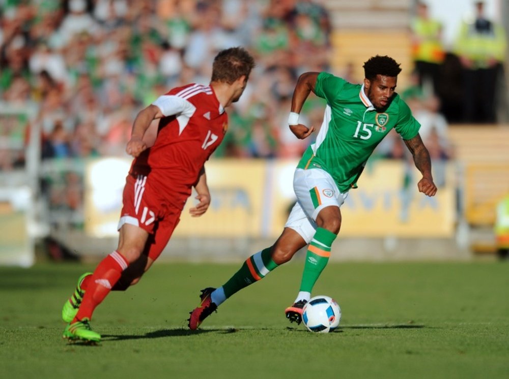 Republic of Irelands Cyrus Christie (R) runs past Belarus midfielder Maksim Valadzko (L) during the international friendly, in Cork on May 31, 2016