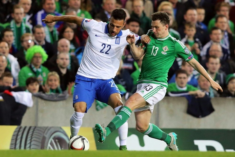 Northern Irelands Corry Evans (R) vies for the ball with Greeces Andreas Samaris during the UEFA Euro 2016 qualifying Group F football match at Windsor Park in Belfast, Northern Ireland, on October 8, 2015