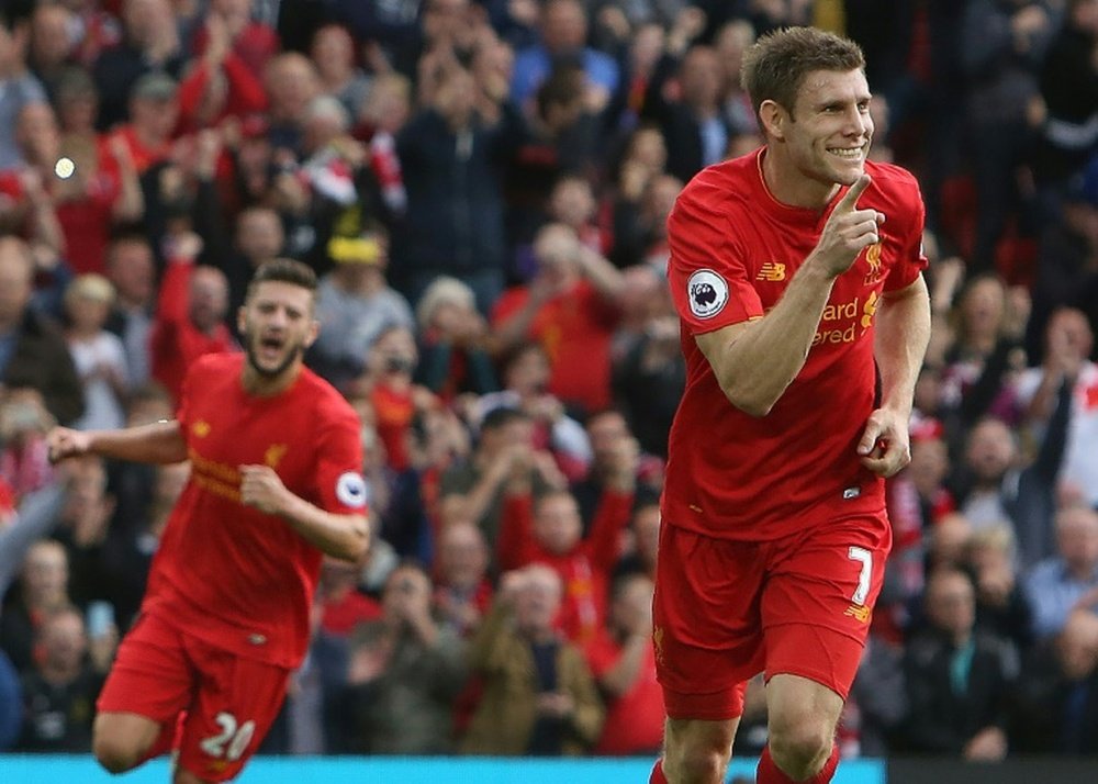 James Milner (right) celebrates after scoring from a penalty kick against Hull City at Anfield on September 24, 2016