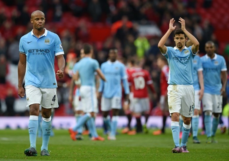 Manchester Citys defender Vincent Kompany (L), pictured on October 25, 2015, admits it is difficult juggling the demands of club and country, but appears to be happy with his decision to play