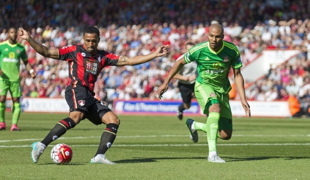 Callum Wilson (left) scores for Bournemouth as Sunderlands Younes Kaboul looks on during a Premier League game at the Vitality Stadium in Bournemouth on September 19, 2015