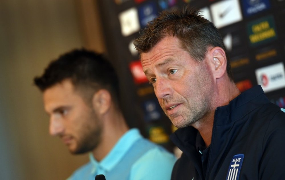 Andreas Samaris (L) rejoins the Greek national football team in the line up announced by head coach Michael Skibbe (R)tain Andreas Samaris (L) attend a press conference in Sydney on June 3, 2016.Australia play Greece in a double-header football international friendlies in Sydney on June 4 and in Melbourne on June 7.