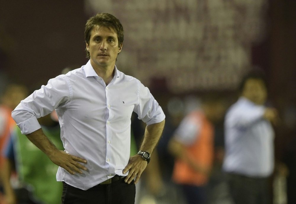 Argentinas Lanus coach Guillermo Barros Schelottos existing coaching qualifications did not pass muster with European footballs ruling body UEFA, prompting his resignation and that of his backroom staff