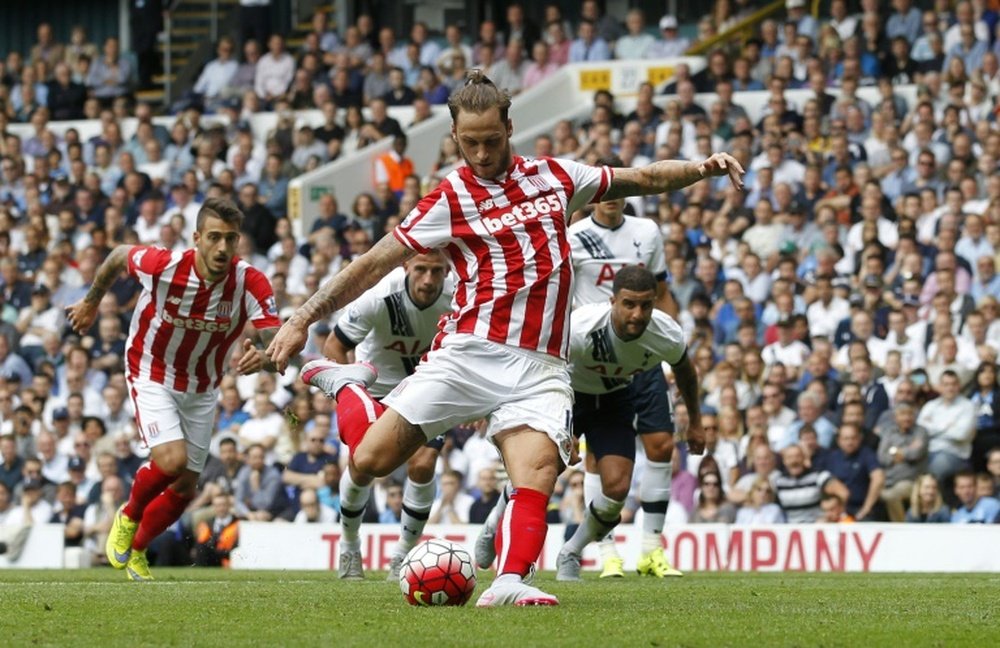 Stoke Citys Austrian striker Marko Arnautovic scores their first goal from the penalty spot during the English Premier League football match between Tottenham Hotspur and Stoke City at White Hart Lane in north London on August 15, 2015