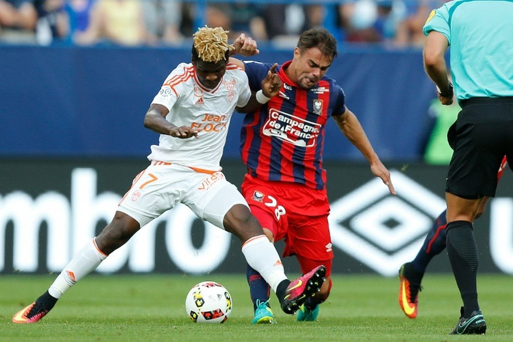 Lorient Gabonese midfielder Didier Ndong (L) is tackled by Caen defender Damien Da Silva. AFP