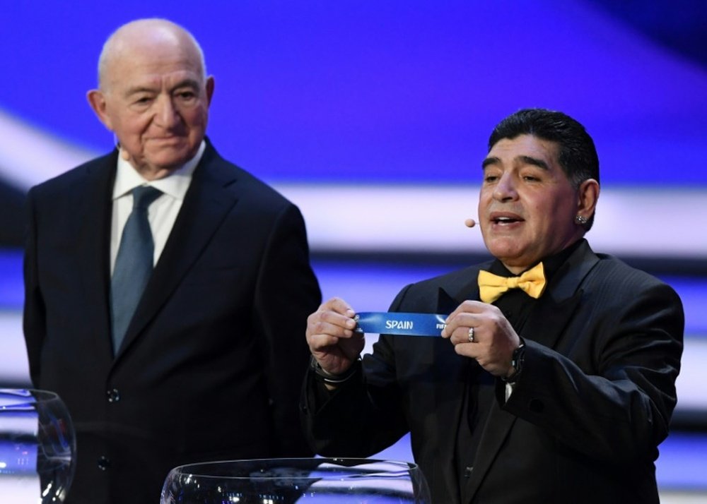 Argentina's Diego Maradona (R) shows the name of