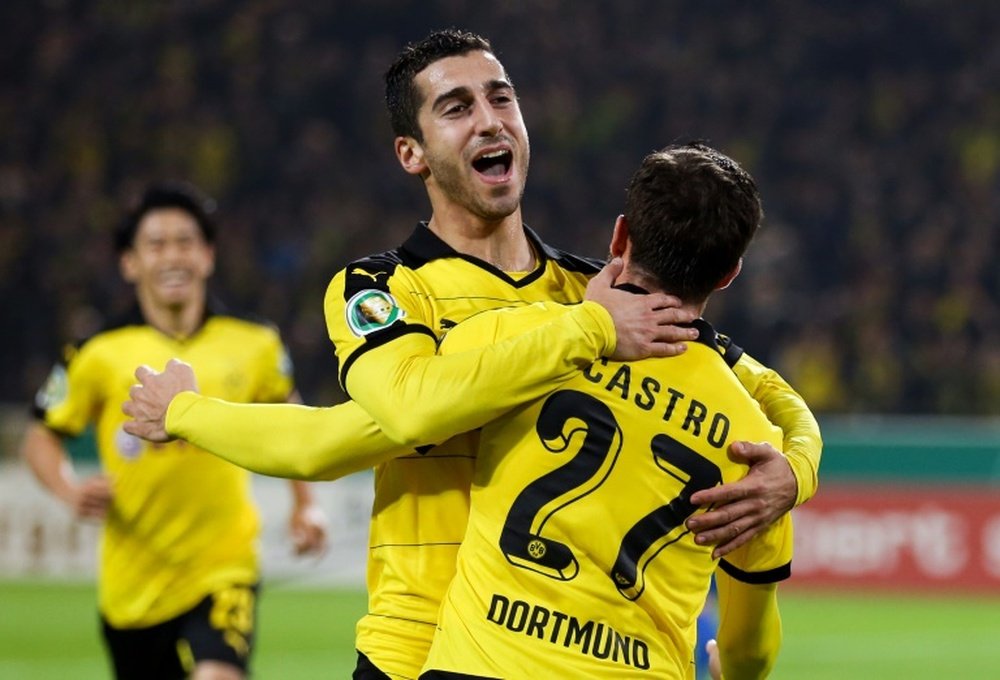 Dortmunds midfielder Gonzalo Castro celebrates scoring with midfielder Henrikh Mkhitaryan during the German Cup DFB second round football match in Dortmund, western Germany on October 28, 2015