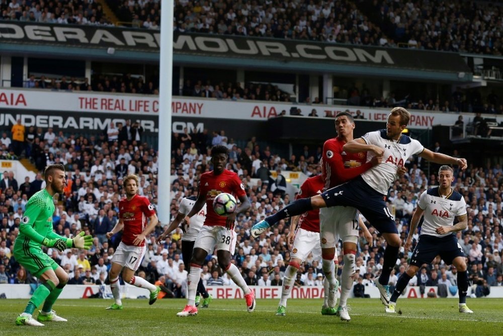 Tottenham Hotspurs striker Harry Kane (R) scores the second goal. AFP