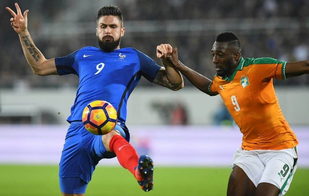 Olivier Giroud vies with Ivory Coast defender Wilfried Kanon. AFP