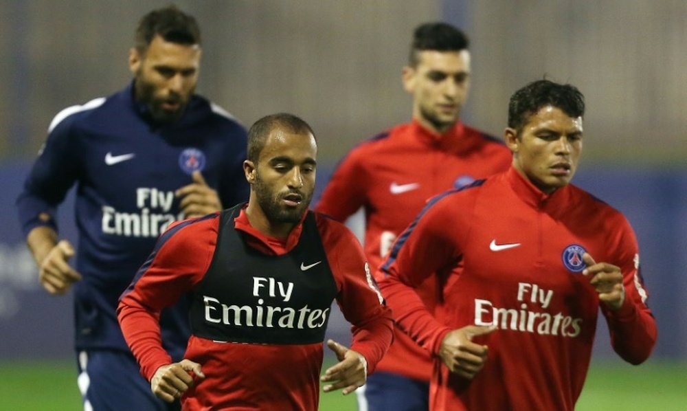 Paris Saint-Germains (PSG) Salvatore Sirigu (L, Back), Javier Pastore (C, back), Lucas Moura (C, front) and Thiago Silva (R) take part in a training session