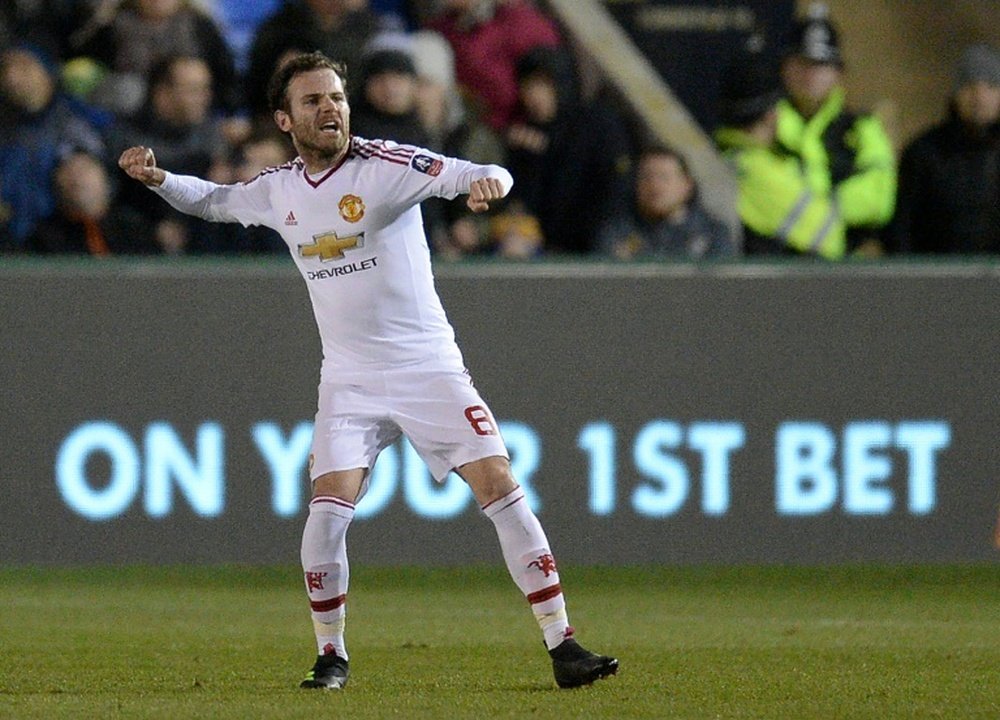 Manchester Uniteds midfielder Juan Mata celebrates scoring his teams second goal during the English FA Cup fifth round football match between Shrewsbury Town and Manchester United in Shrewsbury, England on February 22, 2016
