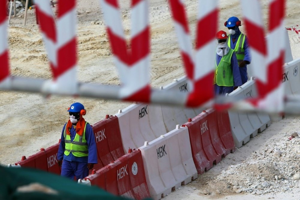 Laborers work at the construction site of the al-Wakrah football stadium. AFP