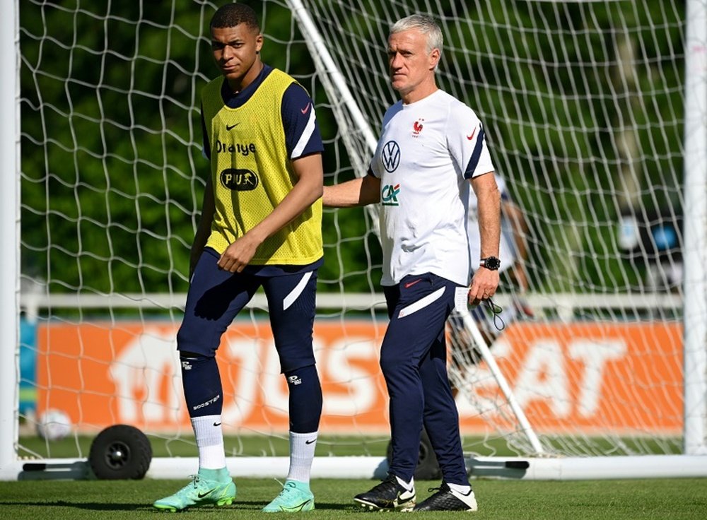 France striker Kylian Mbappe (L) and coach Didier Deschamps (R) prepare for Tuesday's Euro 2020 clash with Germany