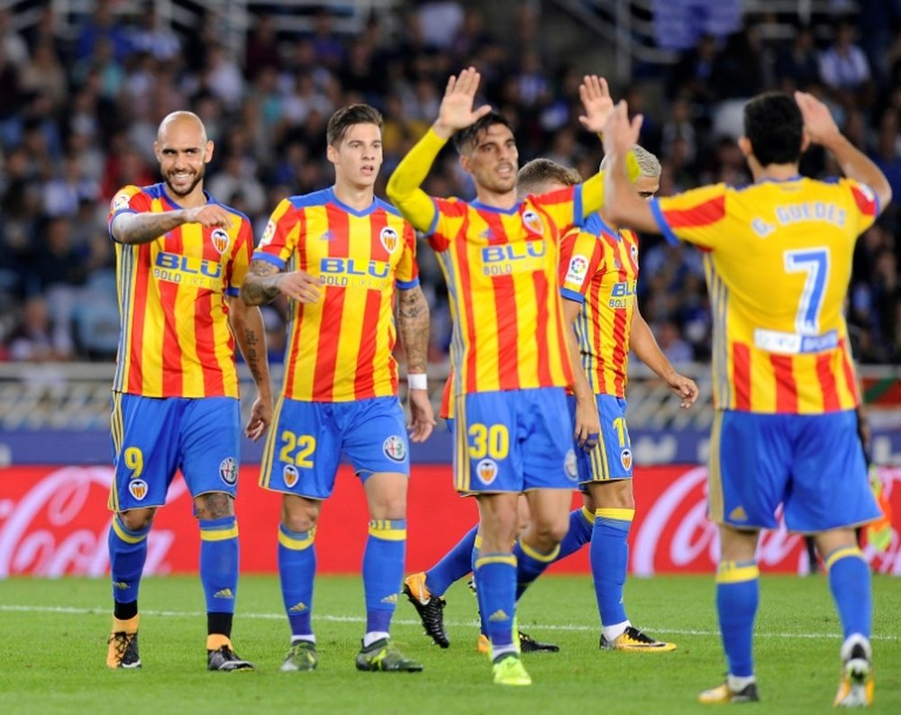 Manager pulls hamstring in celebrating Valencia triumph. AFP