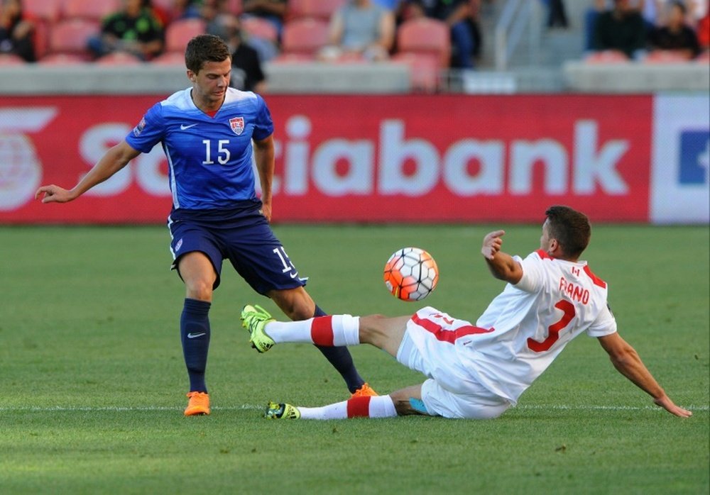 Giuliano Frano (R) of Canada directs the ball away from Marc Pelosi of the US during the first half of the third place CONCACAF Olympic qualifying match, at Rio Tinto Stadium in Sandy, Utah, on October 13, 2015