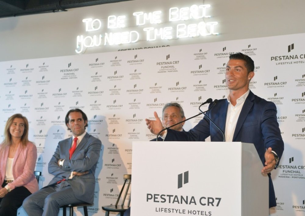 Portuguese forward Cristiano Ronaldo (R) speaks during the opening of Pestana CR7 Hotel in Funchal, on Madeira island on July 22, 2016