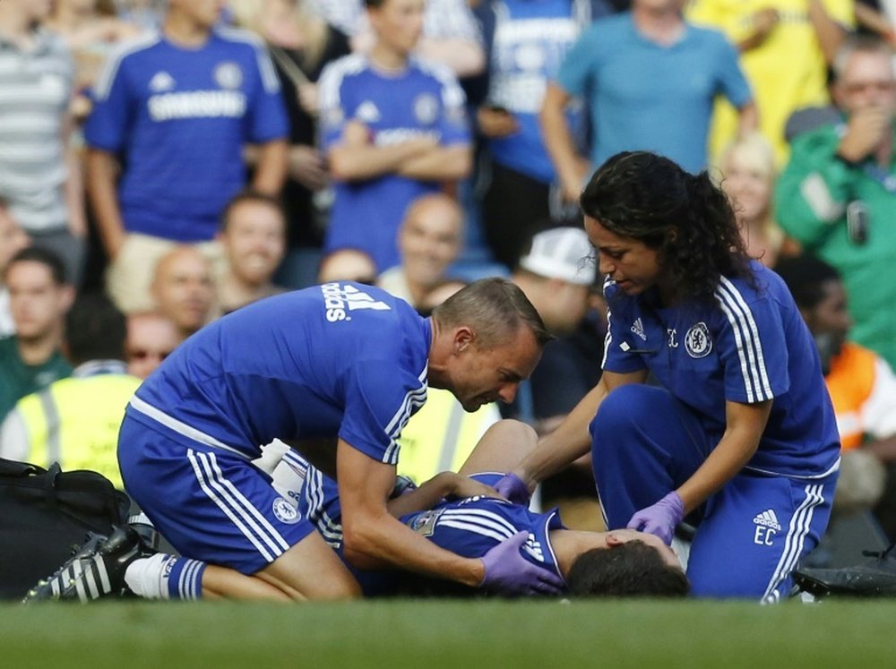 Chelsea doctor (R) Eva Carneiro and head physio Jon Fearn (L) treat Chelseas Belgian midfielder Eden Hazard during the English Premier League football match between Chelsea and Swansea City at Stamford Bridge in London on August 8, 2015