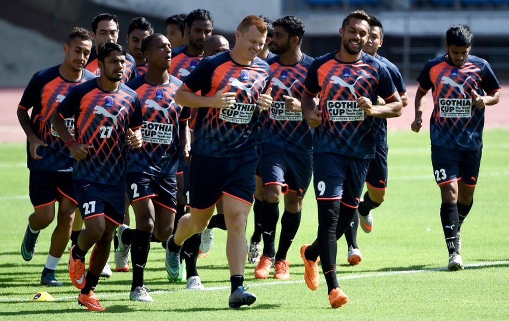 Delhi Dynamos FC players warm up during a training session at the Jawaharlal Nehru Stadium in New Delhi on September 30, 2015
