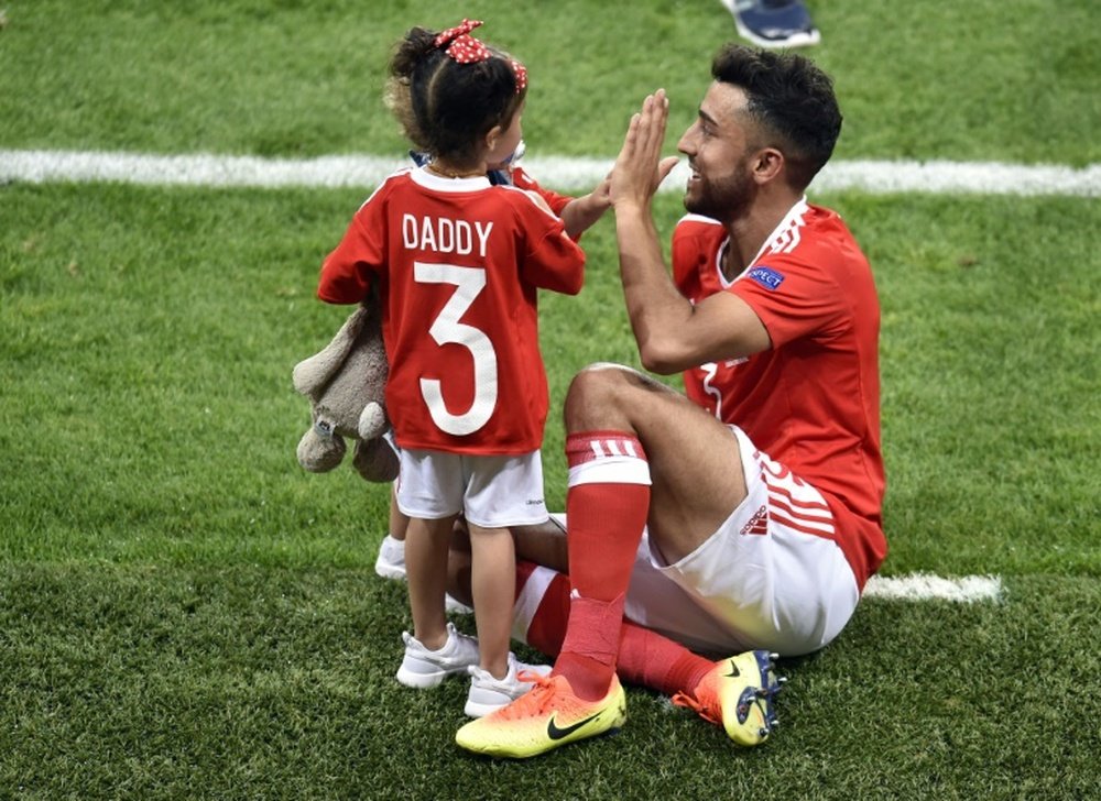 Neil Taylor celebrates with his children after scoring for Wales in the 3-0 win over Russia