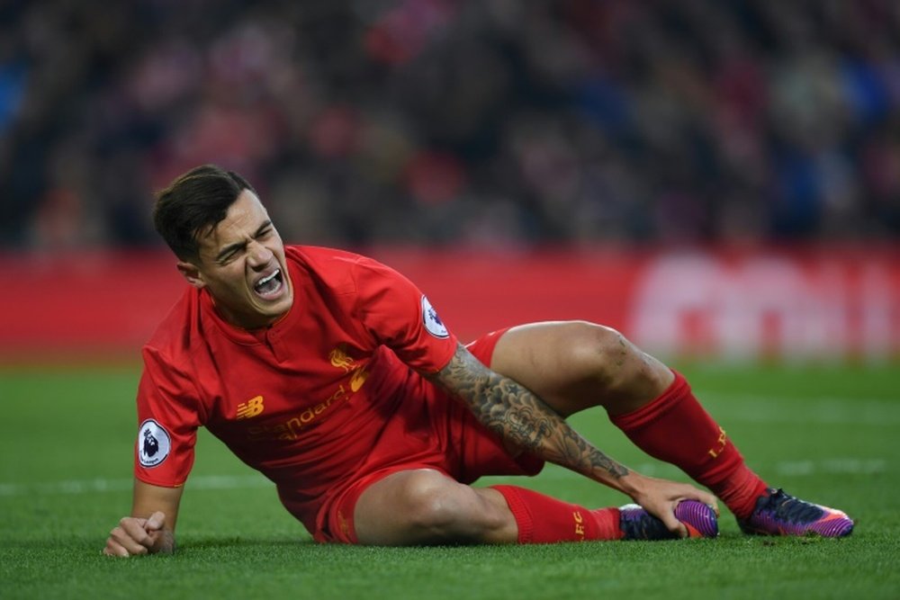 Coutinho sitting on the field. AFP