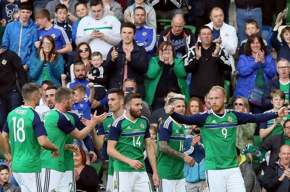 Northern Irelands striker Liam Boyce (R) celebrates with teammates. AFP