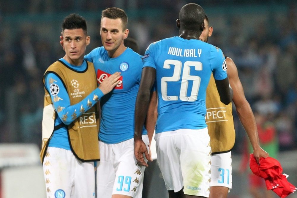 Napoli players celebrate at the end of the UEFA Champions League match against Benfica on September 28, 2016 at the San Paolo stadium in Naples