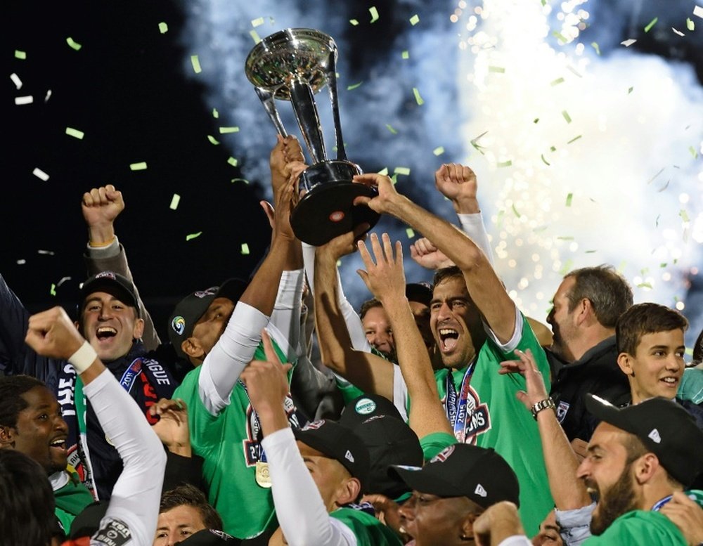 Spanish soccer star Raul (R holding trophy) celebrates with his teammates after the NASL Championship Final match between the NY Cosmos and the Ottawa Fury November 15, 2015 in Hempstead, NY